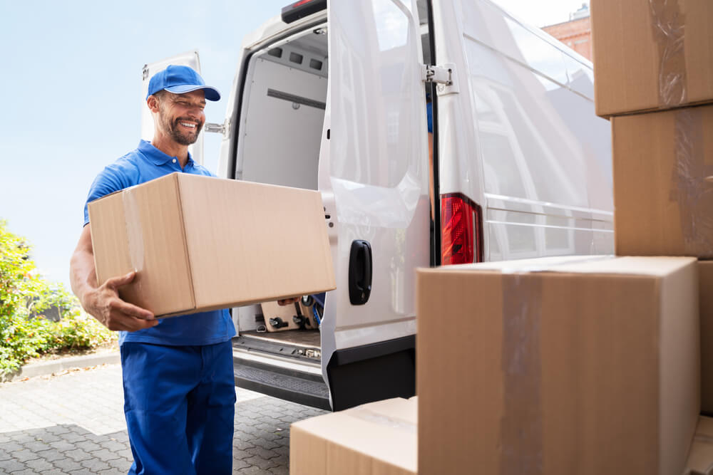 Team Of Movers Carrying Furniture